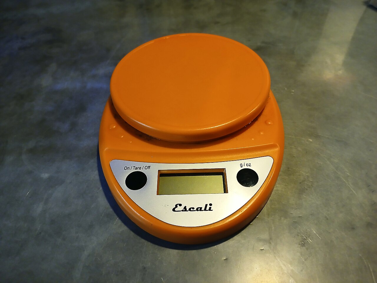 Digital coffee scale weighing ground coffee on a portafilter