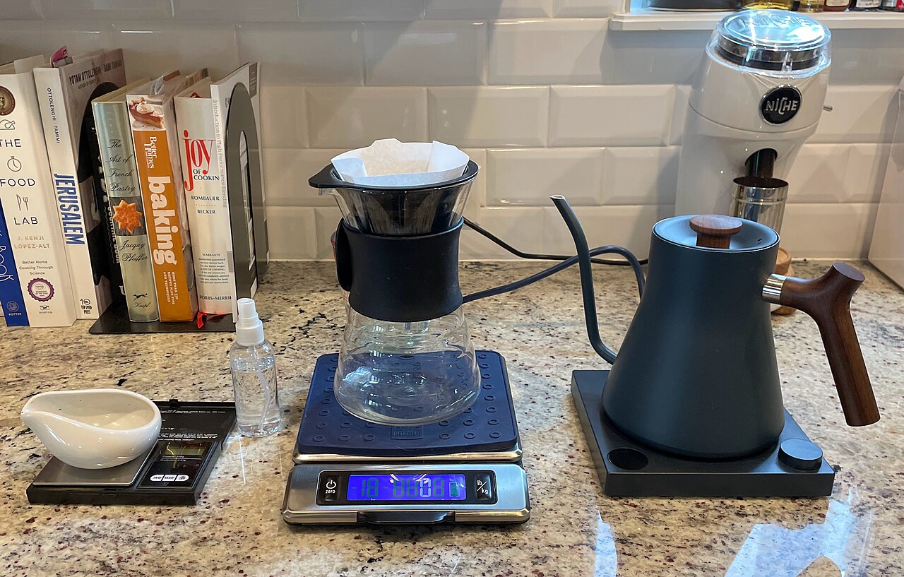 Matte black gooseneck kettle pouring hot water