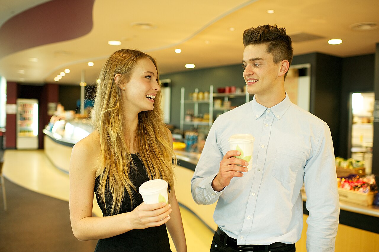 Two people enjoying takeaway coffees together