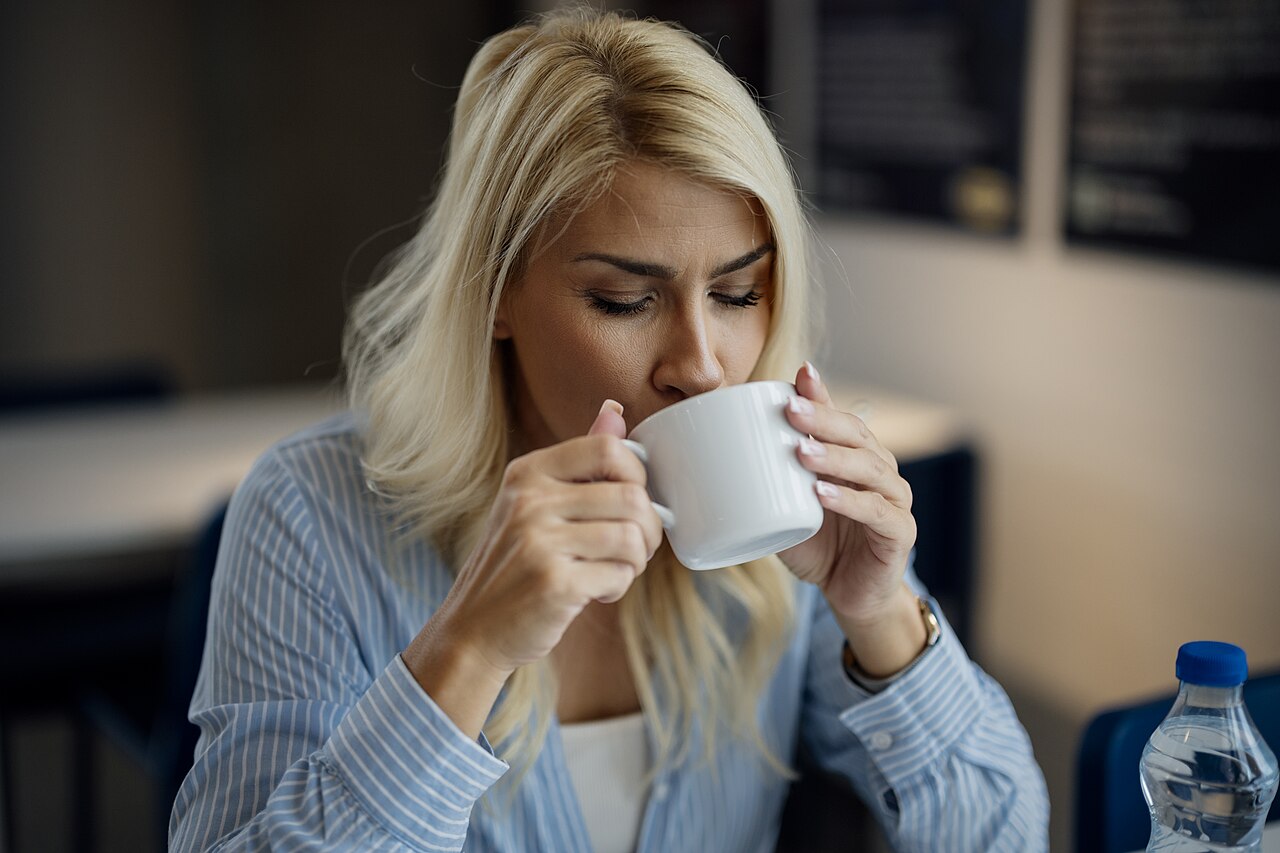 Woman savoring a freshly brewed cup of coffee